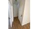 Hallway with wood floors and doors leading to various rooms at 415 Bayou Village Dr, Tarpon Springs, FL 34689