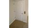 Hallway door has six panels, and the hallway floor is carpeted at 415 Bayou Village Dr, Tarpon Springs, FL 34689