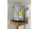 New water heater sits on a wood platform with Energy Guide label visible at 415 Bayou Village Dr, Tarpon Springs, FL 34689