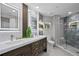 Modern bathroom with a double sink vanity and a glass shower at 4951 Bacopa S Ln # 103, St Petersburg, FL 33715