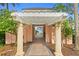 Charming exterior walkway with pergola, leading to serene water views and lush landscaping at 4951 Bacopa S Ln # 103, St Petersburg, FL 33715