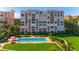 Beautiful exterior view of updated condominiums, lush landscaping, and sparkling community pool at 4951 Bacopa S Ln # 103, St Petersburg, FL 33715