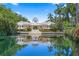 Stunning waterfront building featuring beautiful landscaping and a tranquil water view reflecting its elegant architecture at 4951 Bacopa S Ln # 103, St Petersburg, FL 33715