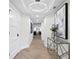 Stunning hallway featuring modern lighting, a decorative table, and exquisite art at 4951 Bacopa S Ln # 103, St Petersburg, FL 33715