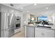 Modern kitchen with stainless appliances, marble countertop, and an open-concept layout at 4951 Bacopa S Ln # 103, St Petersburg, FL 33715