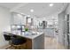 Gorgeous kitchen featuring gray countertops, stainless steel appliances, and an adjacent dining area at 4951 Bacopa S Ln # 103, St Petersburg, FL 33715