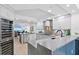 An all-white kitchen featuring a sleek design with stainless steel appliances and marble countertops at 4951 Bacopa S Ln # 103, St Petersburg, FL 33715
