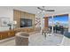 Stylish living room featuring a TV with a decorative wall, and sliding glass doors to the waterfront patio at 4951 Bacopa S Ln # 103, St Petersburg, FL 33715