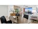 Open-concept living room with modern decor and waterfront view from sliding glass doors to the outdoor patio at 4951 Bacopa S Ln # 103, St Petersburg, FL 33715