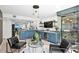 A modern living room features bar, wine fridge, wine cellar, and cozy seating area at 4951 Bacopa S Ln # 103, St Petersburg, FL 33715