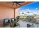 Relaxing outdoor patio with seating area and spectacular waterfront views and palm trees on the lawn at 4951 Bacopa S Ln # 103, St Petersburg, FL 33715