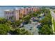 Overhead view of the tennis courts and surrounding tropical landscaping, community buildings, and parking areas at 4951 Bacopa S Ln # 103, St Petersburg, FL 33715