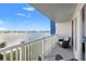 Balcony view overlooking the water with comfortable chairs and a sunny sky at 500 Treasure Island Cswy # 308, Treasure Island, FL 33706