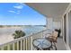 Balcony view overlooking bay waters with table and chairs and city skyline view at 500 Treasure Island Cswy # 308, Treasure Island, FL 33706