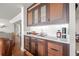 Stylish bar area with wood cabinetry, stone countertop, and built-in lighting, perfect for entertaining at 500 Treasure Island Cswy # 308, Treasure Island, FL 33706