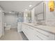 A well-lit bathroom with dual sinks, modern fixtures, and a glass-enclosed shower at 500 Treasure Island Cswy # 308, Treasure Island, FL 33706