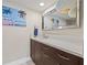 Modern bathroom with a floating vanity, large mirror, and vibrant artwork at 500 Treasure Island Cswy # 308, Treasure Island, FL 33706
