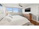 Bright bedroom with a cozy rug, stylish furnishings, and mounted television at 500 Treasure Island Cswy # 308, Treasure Island, FL 33706