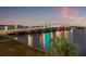 Night view of bridge over bay waters, with decorative lights, and traffic at 500 Treasure Island Cswy # 308, Treasure Island, FL 33706