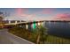 Night view of bridge over bay waters with decorative lights, and traffic at 500 Treasure Island Cswy # 308, Treasure Island, FL 33706
