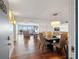 Elegant dining room with modern lighting, wood floors, and seamless flow to outdoor balcony views at 500 Treasure Island Cswy # 308, Treasure Island, FL 33706