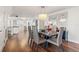 Bright dining area with wood floors, a contemporary chandelier, and an open view to the modern kitchen at 500 Treasure Island Cswy # 308, Treasure Island, FL 33706