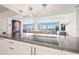 Modern kitchen with stainless steel appliances, stone countertops, and open-concept living space at 500 Treasure Island Cswy # 308, Treasure Island, FL 33706