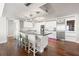 Modern, all-white kitchen boasts a spacious island with seating and high-end stainless steel appliances at 500 Treasure Island Cswy # 308, Treasure Island, FL 33706