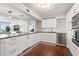 Bright and open kitchen with stainless steel appliances, modern cabinets, and adjacent living area at 500 Treasure Island Cswy # 308, Treasure Island, FL 33706
