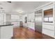 Bright kitchen with modern appliances, white cabinets, hardwood floors, and a stainless steel refrigerator at 500 Treasure Island Cswy # 308, Treasure Island, FL 33706