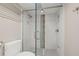 Walk in shower with white tiled walls and glass surround at 500 Treasure Island Cswy # 308, Treasure Island, FL 33706