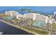 Aerial view of building, tennis courts, parking, and water views at 5915 Sea Ranch Dr # 703, Hudson, FL 34667