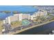 Aerial view of building, tennis courts, parking, and water views at 5915 Sea Ranch Dr # 703, Hudson, FL 34667