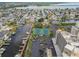 An aerial view of tennis courts, docks, parking lot, and condo building at 5915 Sea Ranch Dr # 703, Hudson, FL 34667