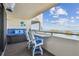 Cozy condo balcony with comfortable blue seating and a stunning view of the bay at 5915 Sea Ranch Dr # 703, Hudson, FL 34667