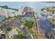 An aerial view of community amenities including tennis courts, a parking lot, and docks at 5915 Sea Ranch Dr # 703, Hudson, FL 34667