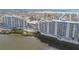 An aerial view of a waterfront condo building with a pool on a sunny day at 5915 Sea Ranch Dr # 703, Hudson, FL 34667