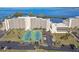 Beautiful condo building with tennis courts, parking, and lush landscaping near a body of water at 5915 Sea Ranch Dr # 703, Hudson, FL 34667