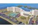 Beautiful condo building with tennis courts and parking, near a body of water with lush greenery at 5915 Sea Ranch Dr # 703, Hudson, FL 34667