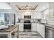 Modern kitchen features stainless steel appliances, granite countertops, and white cabinetry at 5915 Sea Ranch Dr # 703, Hudson, FL 34667