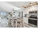 Bright, open kitchen with stainless appliances, a dining area, and views to the living area at 5915 Sea Ranch Dr # 703, Hudson, FL 34667