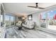 Bright living room boasts a ceiling fan, comfortable seating, and sliding glass doors to a patio at 5915 Sea Ranch Dr # 703, Hudson, FL 34667