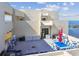 Outdoor patio space with ocean view features dining area with chairs and tables, lounge furniture and grill at 5915 Sea Ranch Dr # 703, Hudson, FL 34667