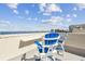 Rooftop deck featuring white Adirondack chairs with blue trim overlooking a gorgeous ocean view at 5915 Sea Ranch Dr # 703, Hudson, FL 34667