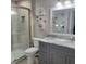 Modern bathroom featuring a glass shower and gray vanity with ample storage at 6421 Banyan Blvd # 302, New Port Richey, FL 34652