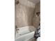 Modern bathtub with brushed nickel fixtures and tiled walls, perfect for relaxation at 6421 Banyan Blvd # 302, New Port Richey, FL 34652