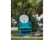 Private beach club sign with inviting turquoise chair, set among lush greenery at 6421 Banyan Blvd # 302, New Port Richey, FL 34652