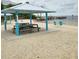 Beach with picnic tables and covered seating, offering relaxation and scenic water views at 6421 Banyan Blvd # 302, New Port Richey, FL 34652