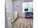 Bright Bedroom featuring a crib, desk, and modern decor at 6421 Banyan Blvd # 302, New Port Richey, FL 34652