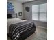 Bright bedroom featuring a comfortable bed, window, and stylish decor at 6421 Banyan Blvd # 302, New Port Richey, FL 34652